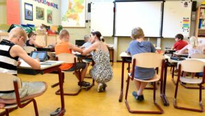 Teacher helping a student with work in a classroom