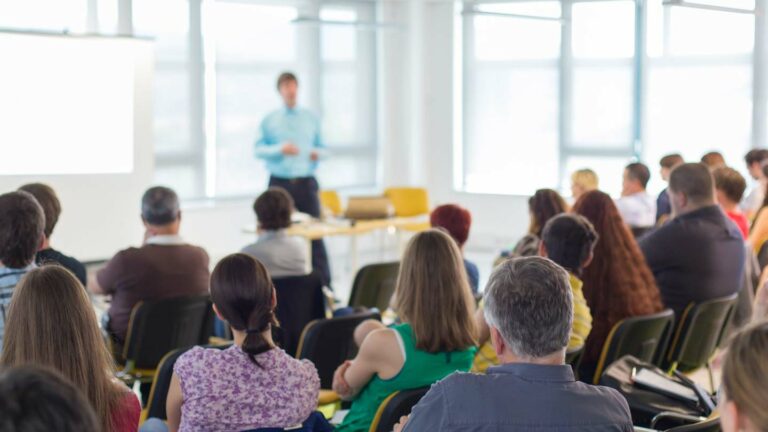 Instructor at a training course standing in front of attendees