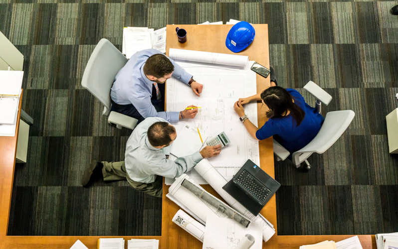 Employees creating an emergency response plan for workplace safety.