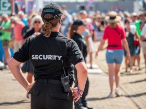 Security guard stationed in front of crowd, to protect a public event
