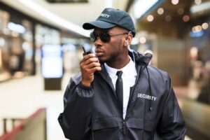 Security guard personnel with walkie talkie and earpiece for retail locations