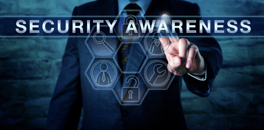 Businessman dressed in the suit with text reading Security Awareness and security themed images of icons grouped in a circle